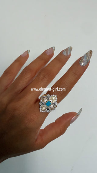 Luxury turquoise ring worn on hand with gold diamond design by Elegant Girl