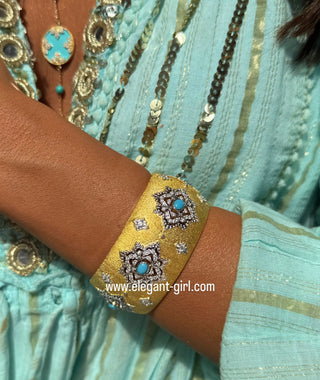 Elegant turquoise bangle on wrist with Italian gold engraving and diamond accents by Elegant Girl